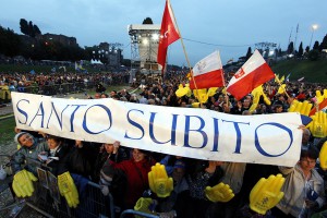 Pilgrims hold a sign that reads, "santo subito" ("sainthood now"), during a vigil on the eve of the beatification of Pope John Paul II at the ancient Circus Maximus in Rome April 30. (CNS photo/Paul Haring) (April 30, 2011) See JPII-VIGIL April 30, 2011.